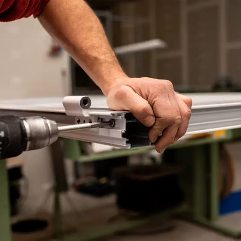 Technician repairing a sliding glass door in a Paradise Valley home, working on rollers, lock, track, and screen door with tools